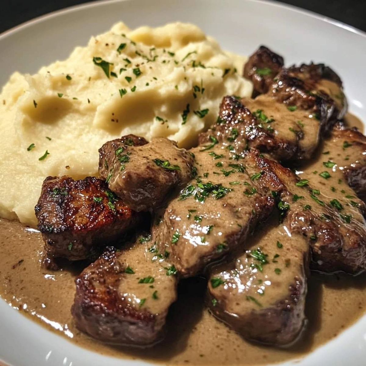 Cajun Steak Bites with Cheesy Mashed Potatoes and Rich Parmesan Sauce