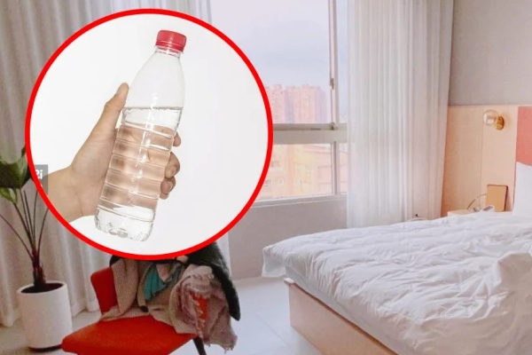 Why should you throw a bottle of water under the bed as soon as you check into a hotel?